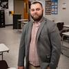30 Under 30 Honoree Joseph Curry smiling and standing in his classroom