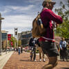 Liacouras walk at Temple University busy with students, Charles Library, Temple flags, and the bell tower in the background.
